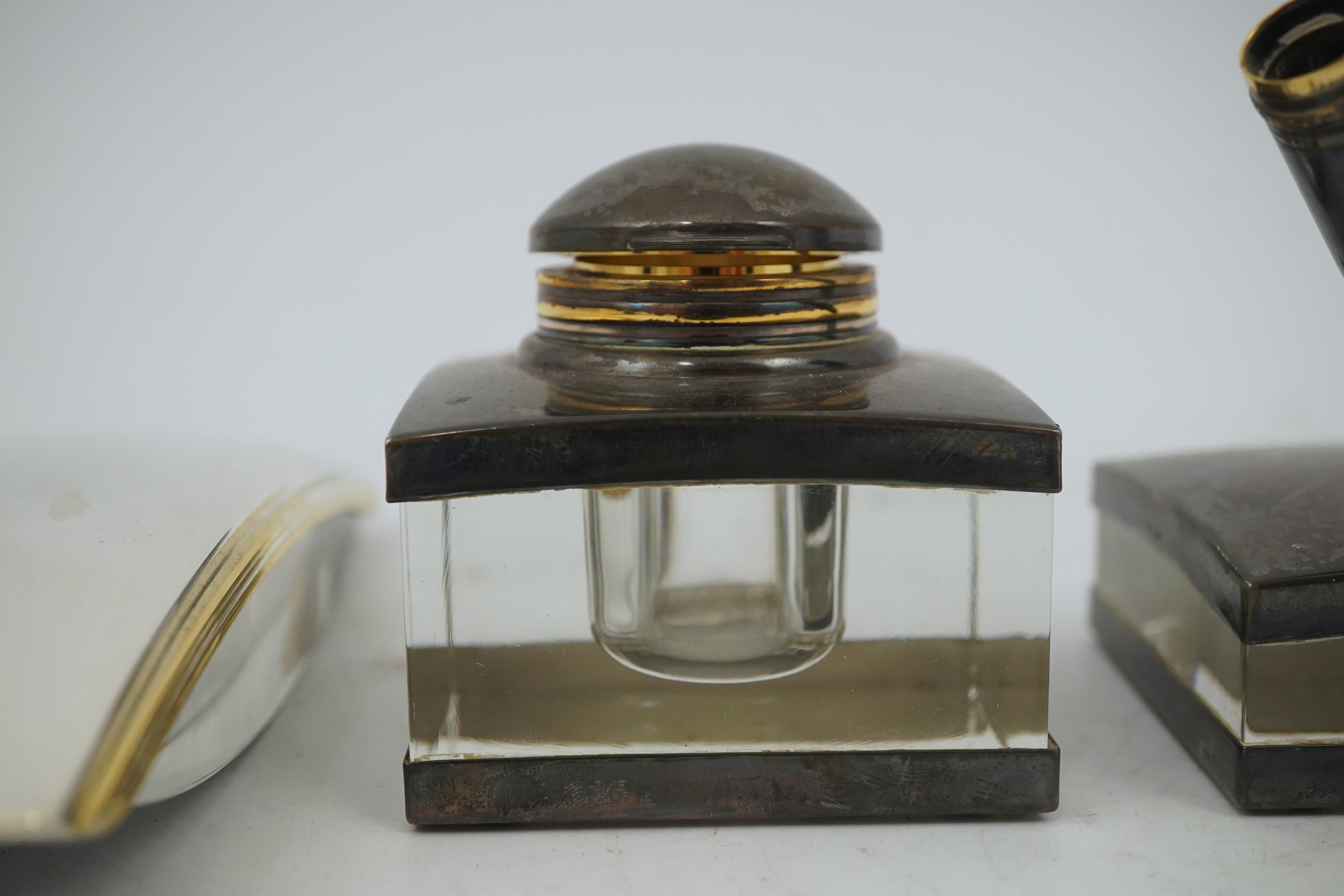 A Montblanc three piece German silver and glass desk set comprising pen stand, inkwell and blotter, each glass mounted, silver engraved with the Montblanc logo